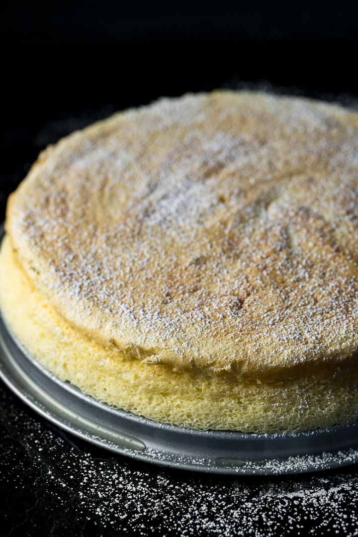 souffle cheesecake dusted with powdered sugar on a cake plate