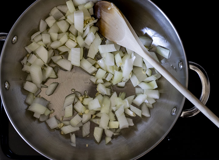 chopped onions being sauteed in a pan