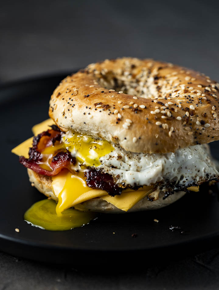 bagel breakfast sandwich with egg and bacon on a plate