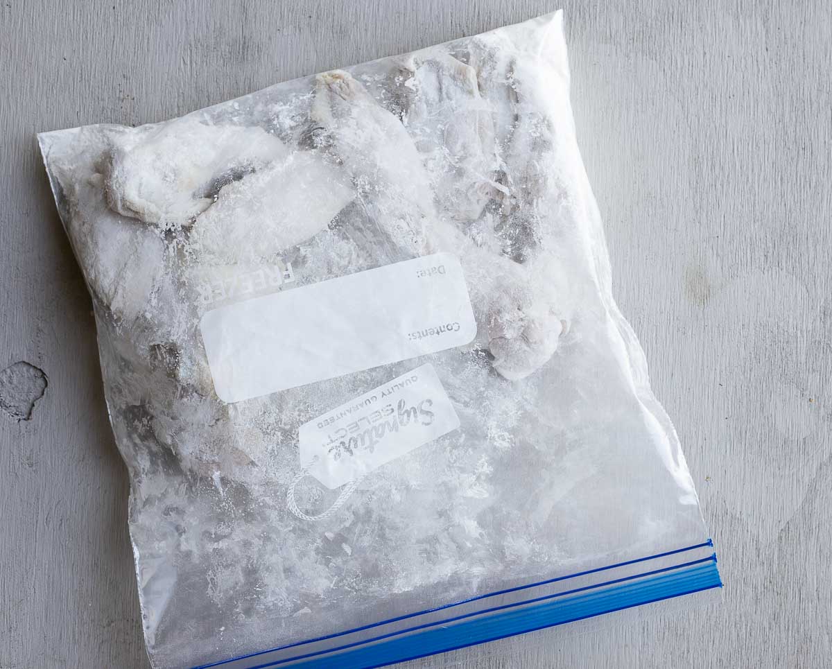 chicken wings covered in flour in a ziplock bag