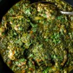 chicken saag curry (spinach curry) in a bowl with a spoon
