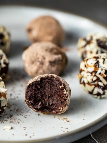 chocolate truffle with a bite taken out on a plate