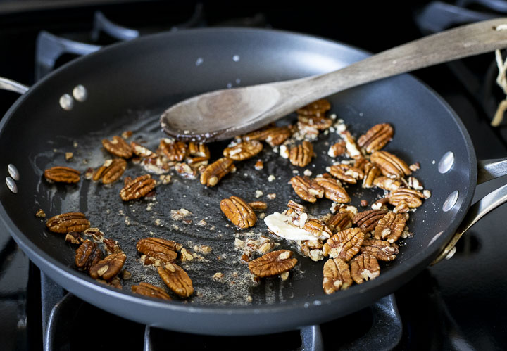 pecans in a skillet with butter