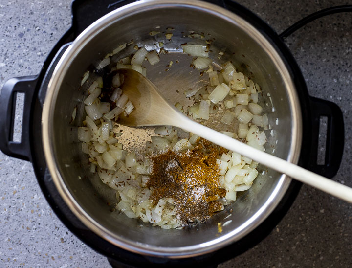 onions and spices cooking in a pot