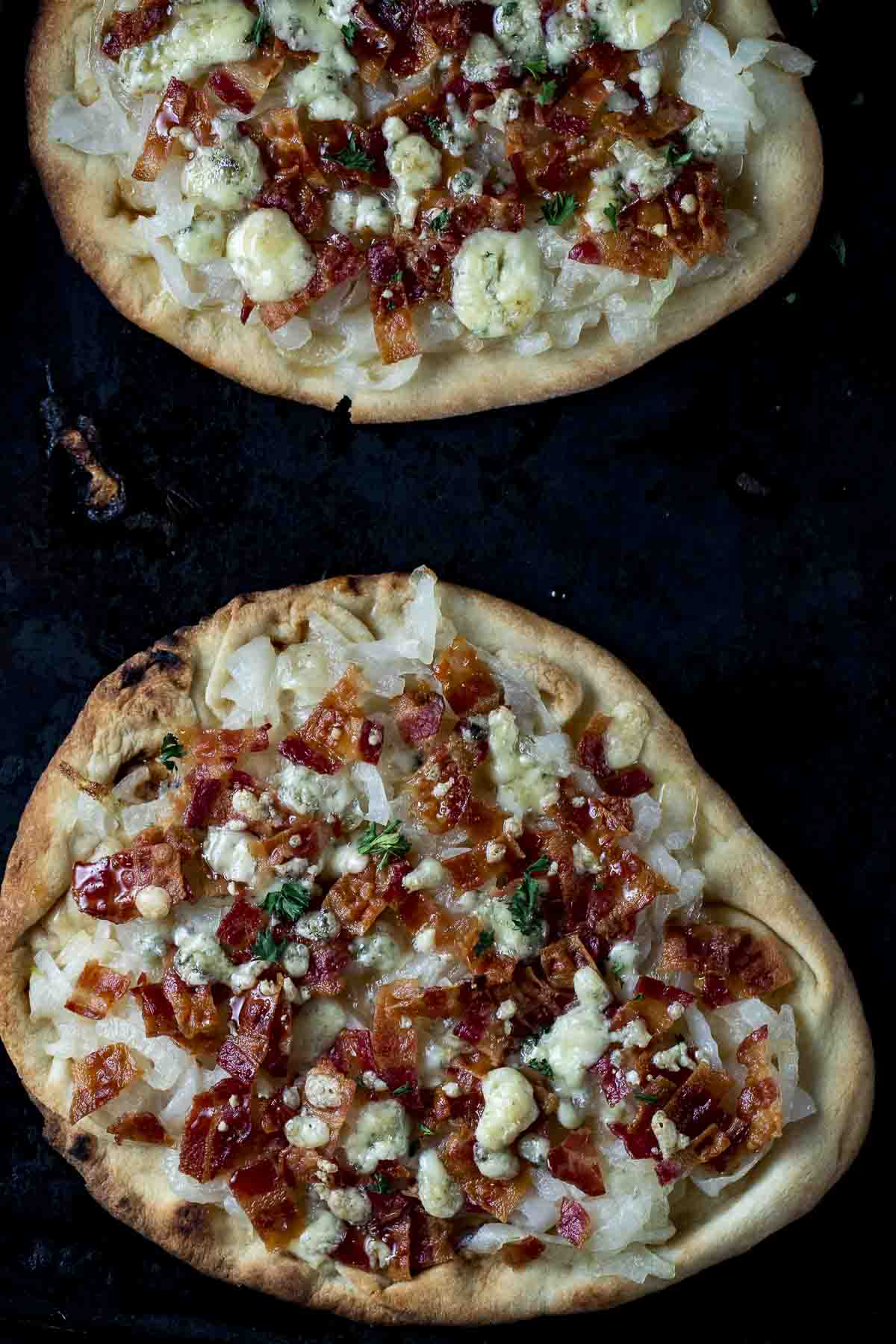 2 flatbread pizzas on a baking sheet