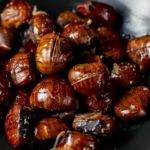 roasted chestnuts in a bowl with shallots and orange zest