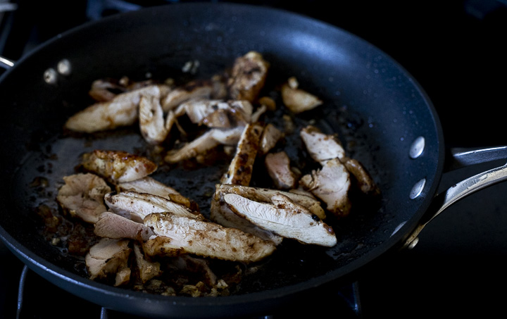 sliced chicken cooking in a skillet