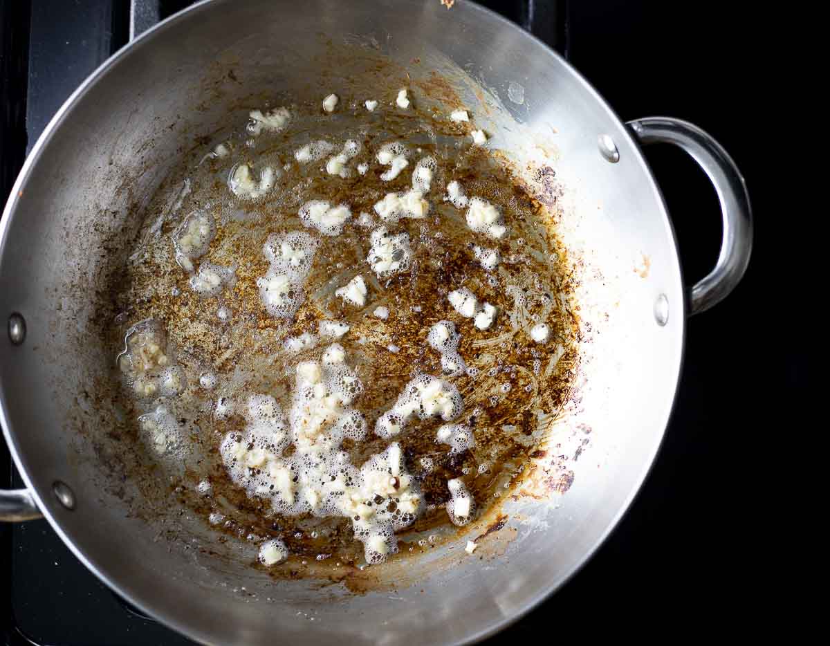minced garlic frying in a skillet