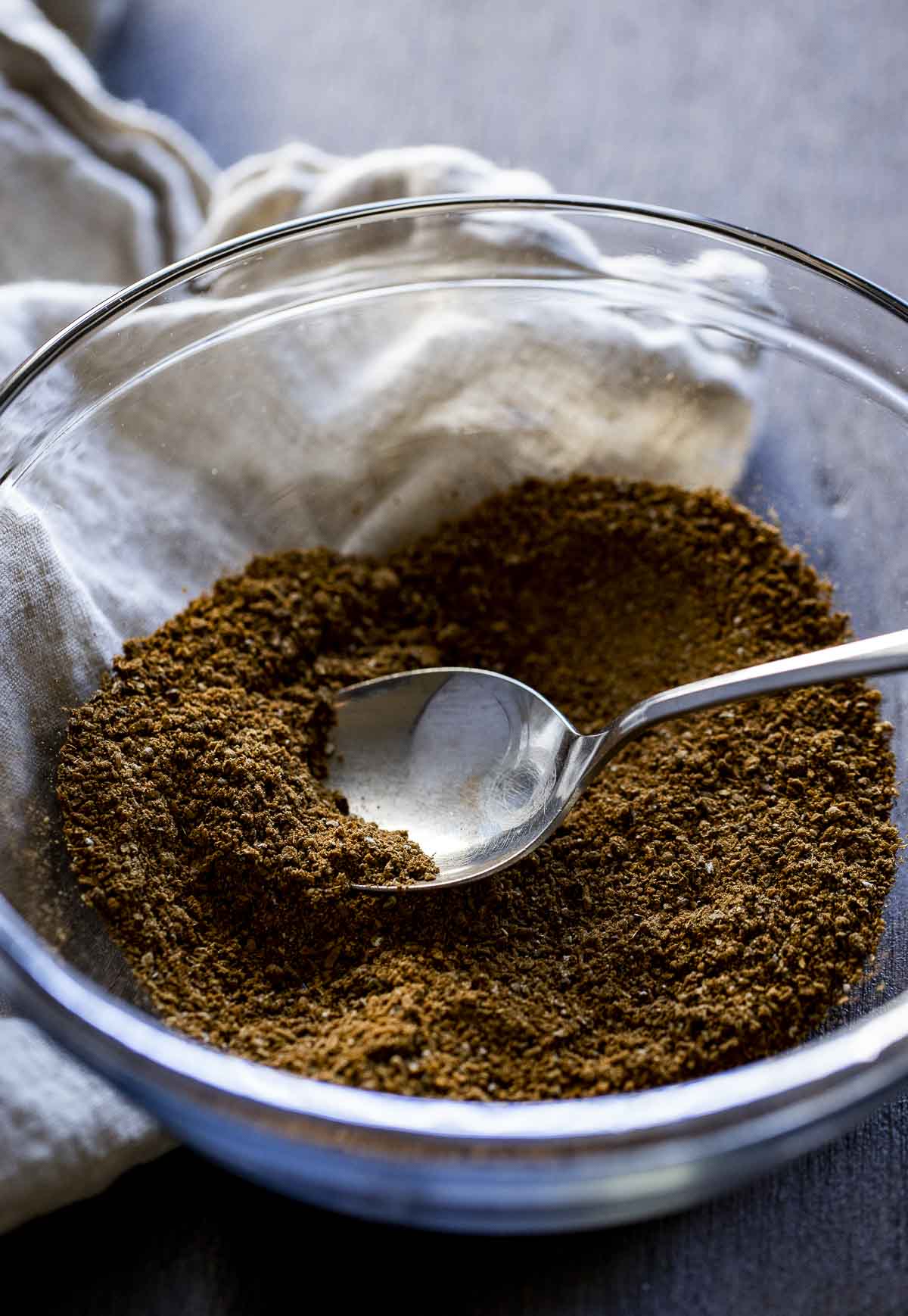 ground spices in a bowl with a spoon