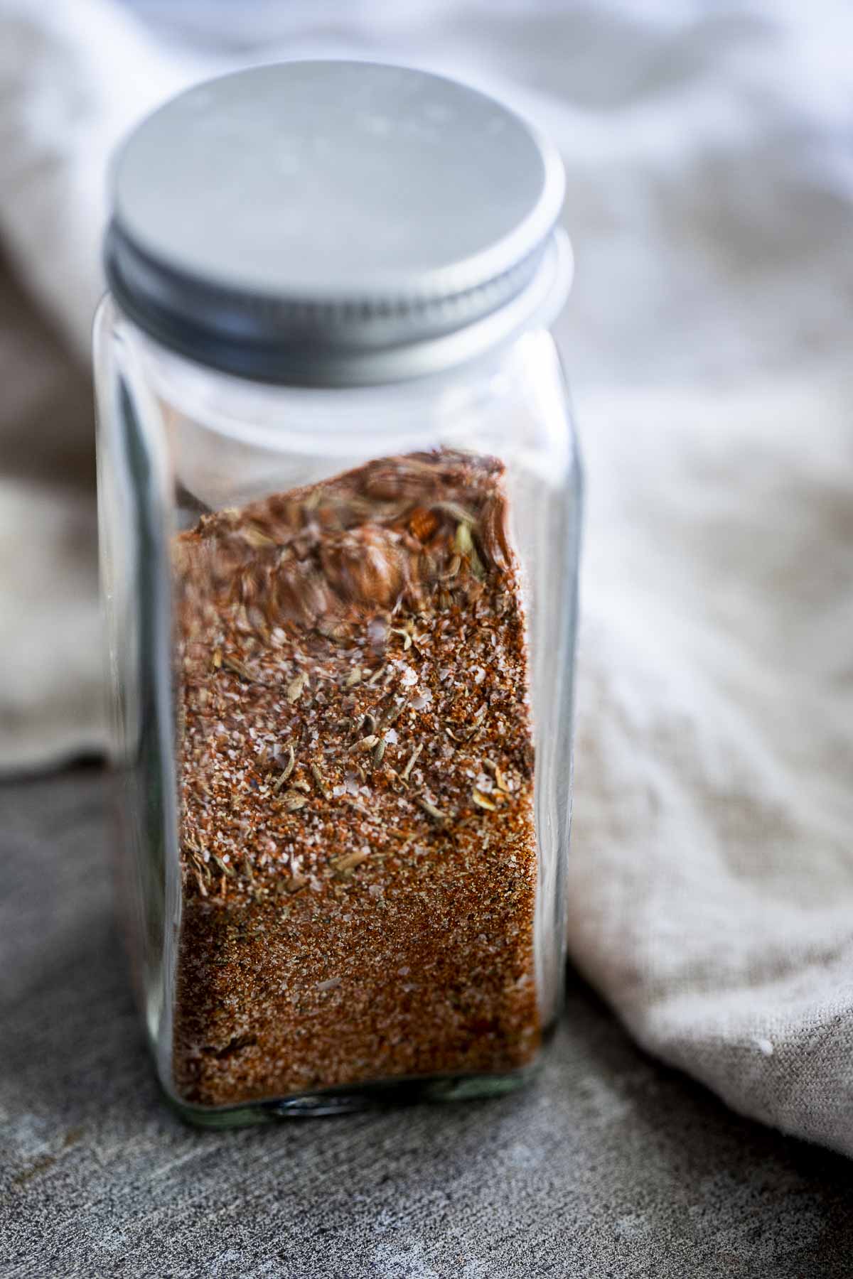 red colored seasoning in a glass jar