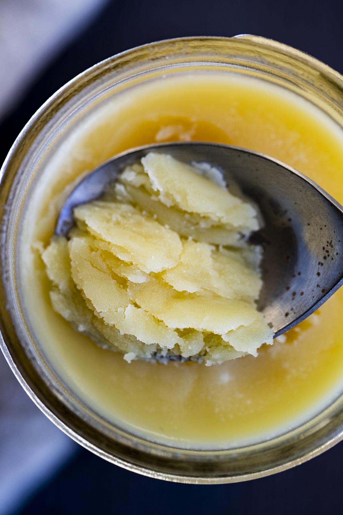 a spoon with solid ghee on it
