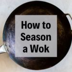 a seasoned wok with text overlay
