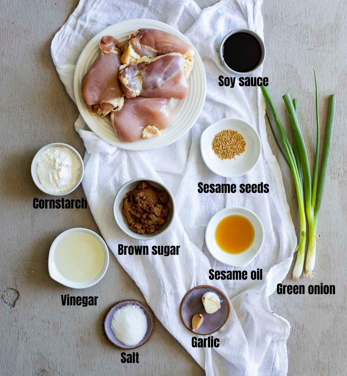 Ingredients to make sesame chicken arranged individually and labelled.