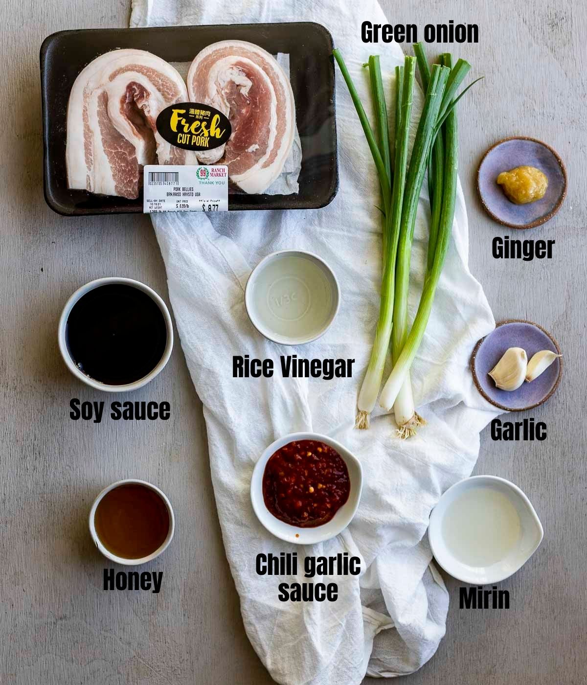 Ingredients to make sous vide pork belly arranged individually and labelled.