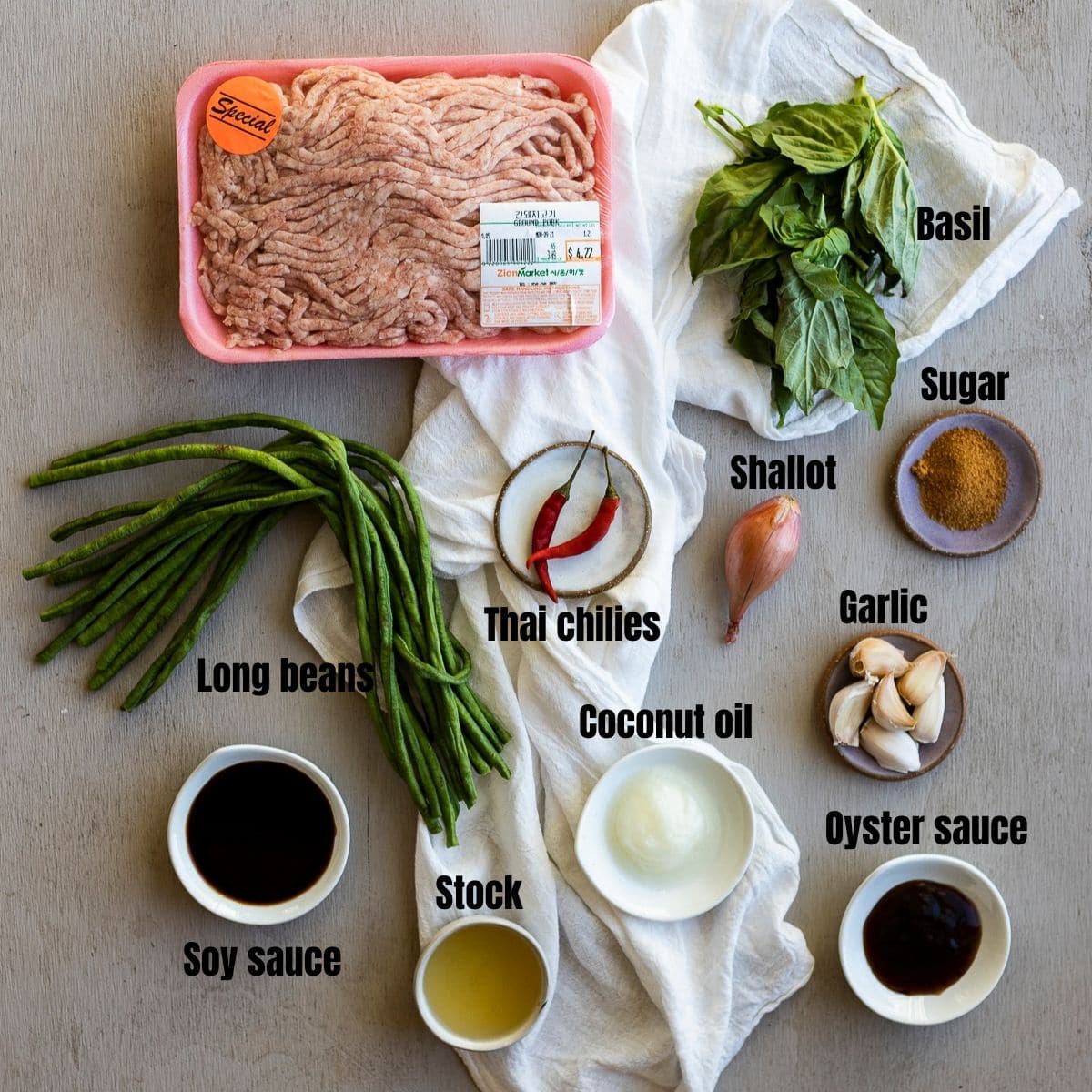 Ingredients to make Thai basil pork arranged individually and labelled.