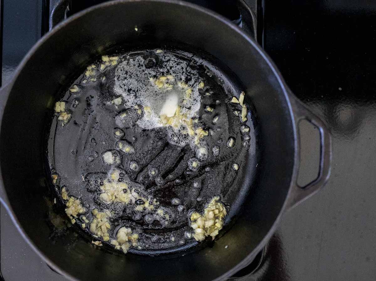 garlic sautéing in a pot with butter