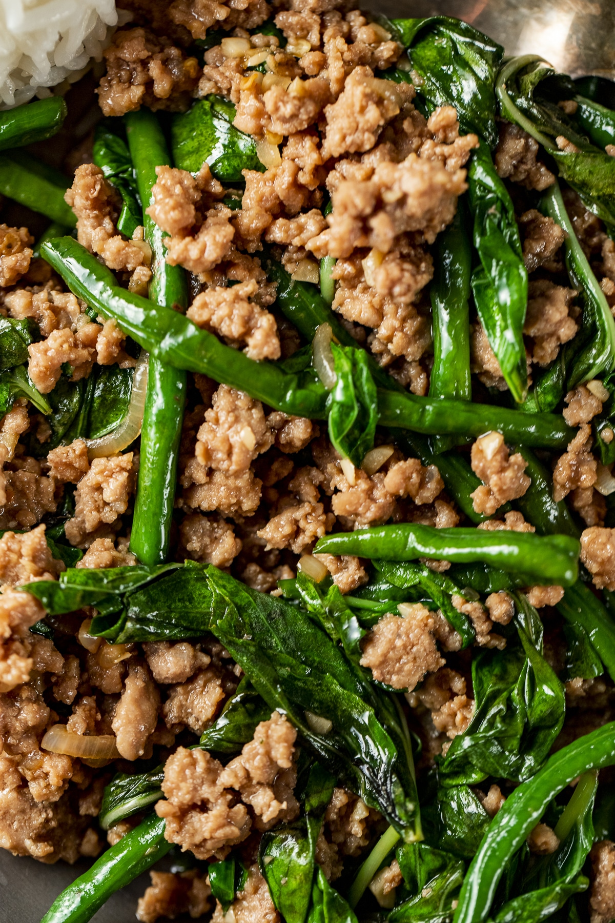 Close up view of Thai basil stir fry with ground pork, long beans and basil.
