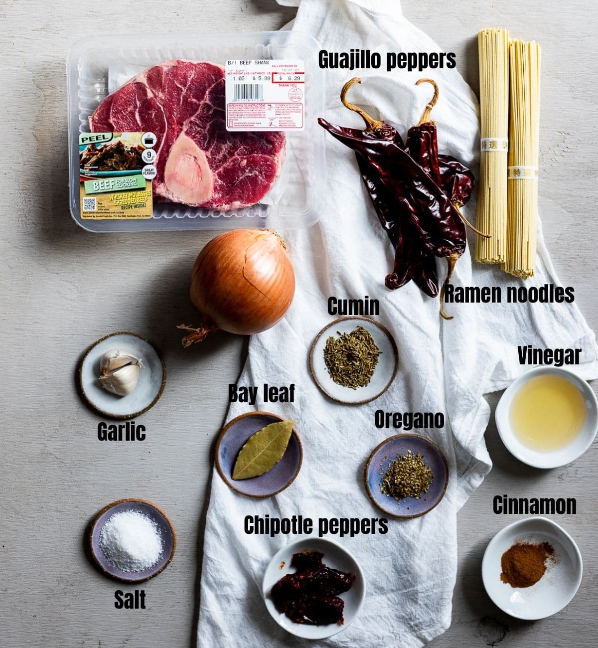 Ingredients to make birria ramen arranged individually and labelled.