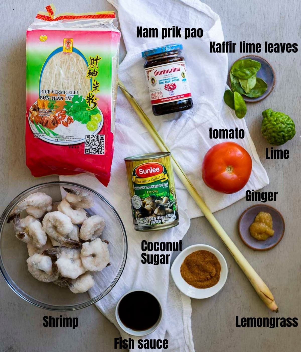 Ingredients to make tom yum noodle soup arranged individually and labelled.