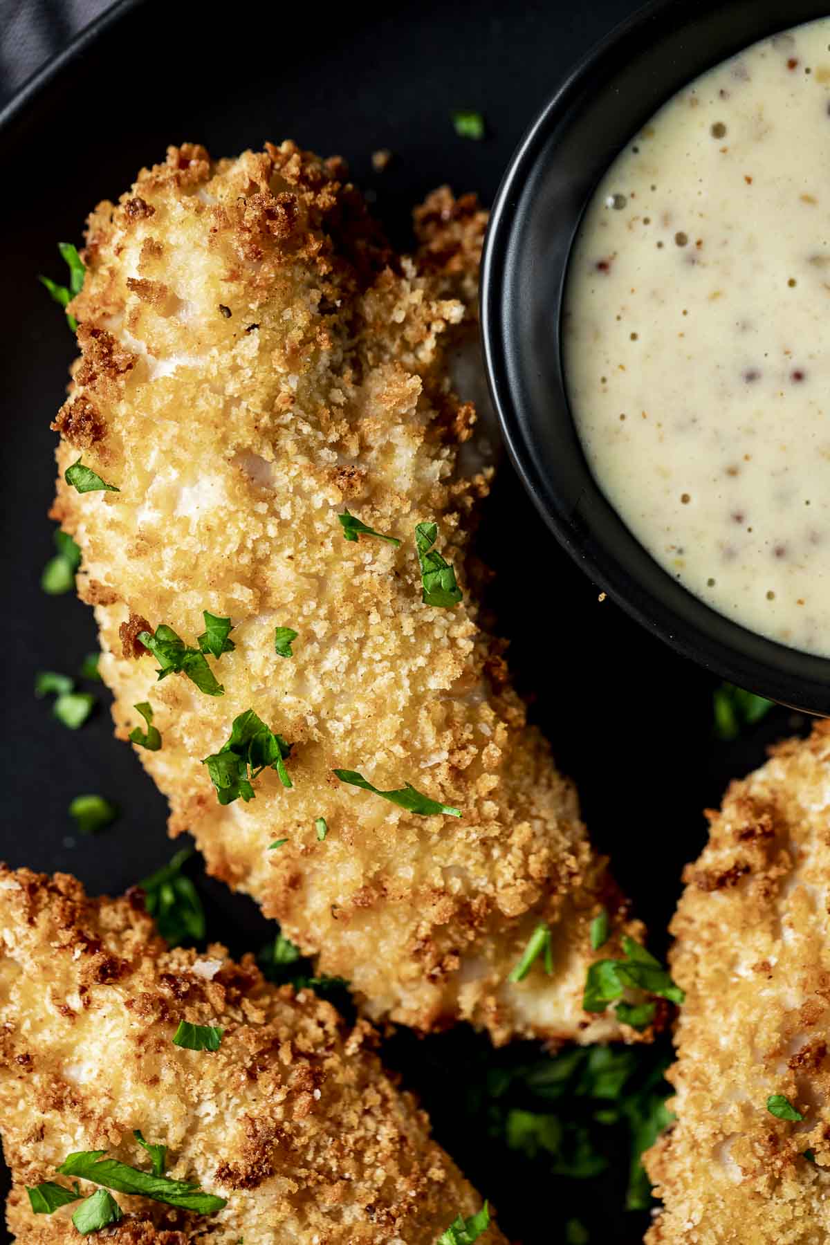 Close up view of a crispy breaded chicken tender.