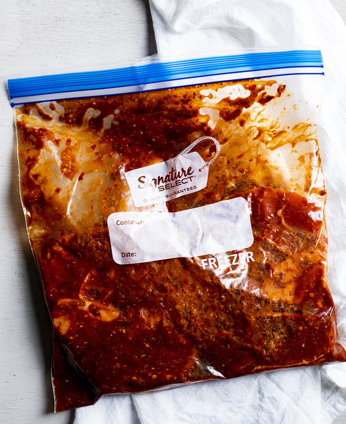Beef shank with marinade in a ziplock bag.