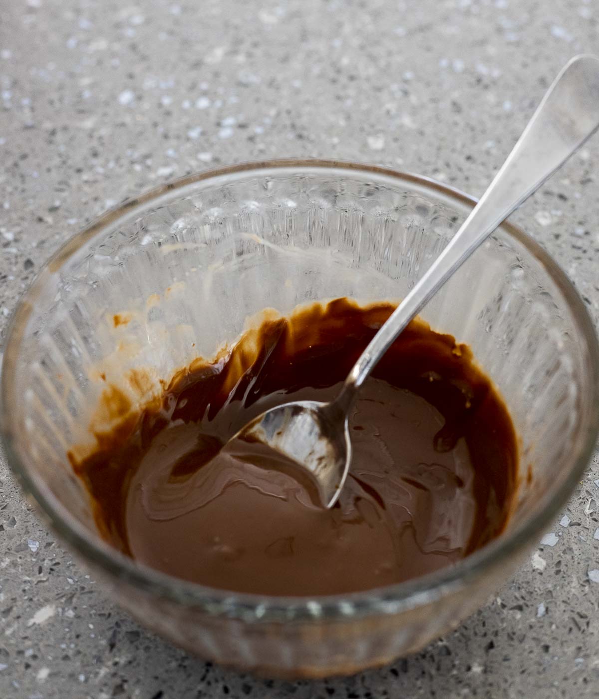 chocolate sauce in a bowl with a spoon