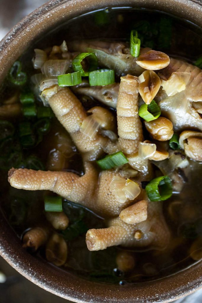 cooked chicken feet in broth with green onions