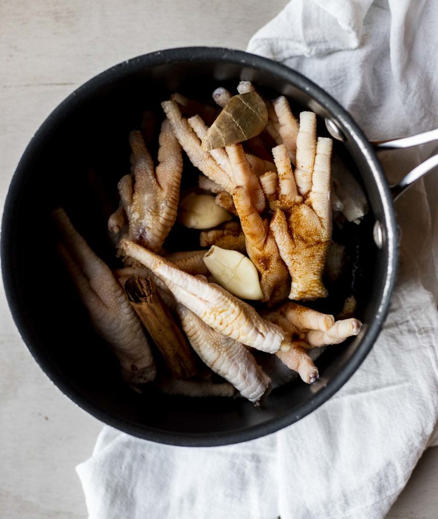raw chicken feet in a large pot