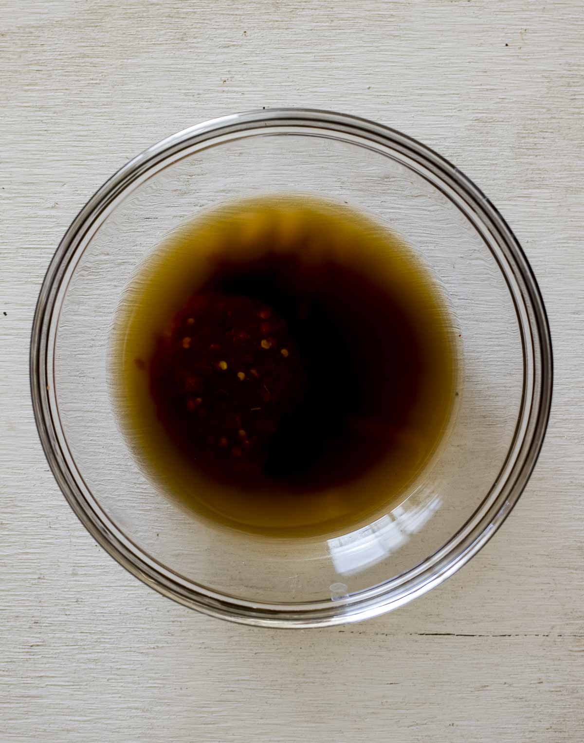 a glass bowl of brown liquid