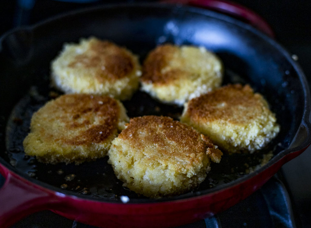 browned risotto cakes in a skillet