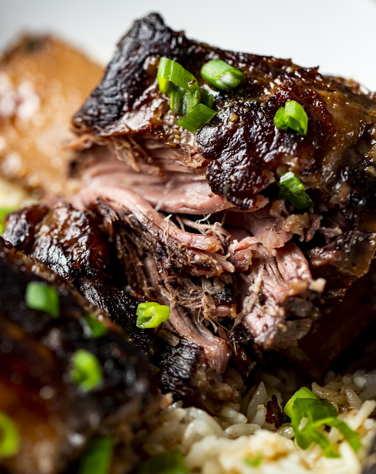 Close up view of the meaty and juicy texture of short ribs.