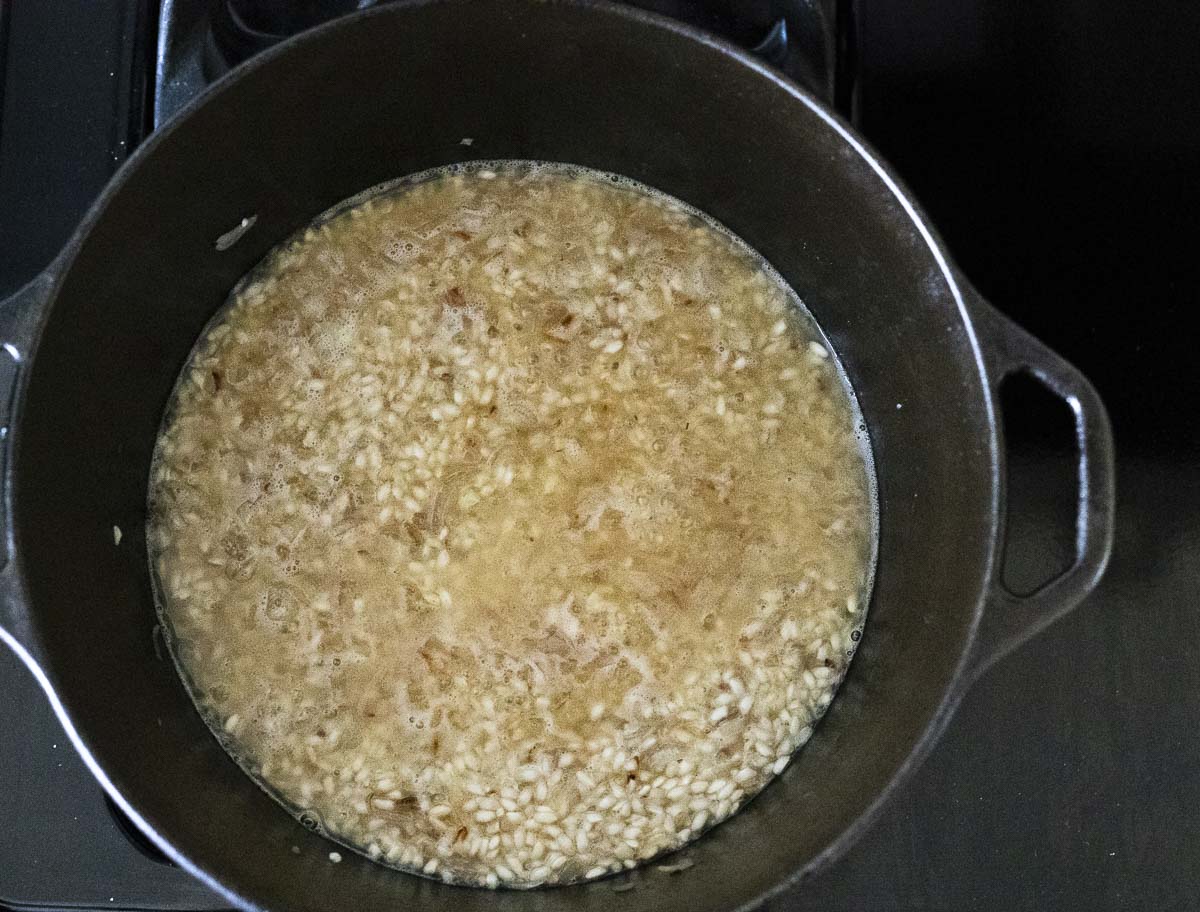 rice cooking in liquid in a pot