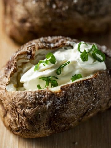 baked potato filled with sour cream and green onions