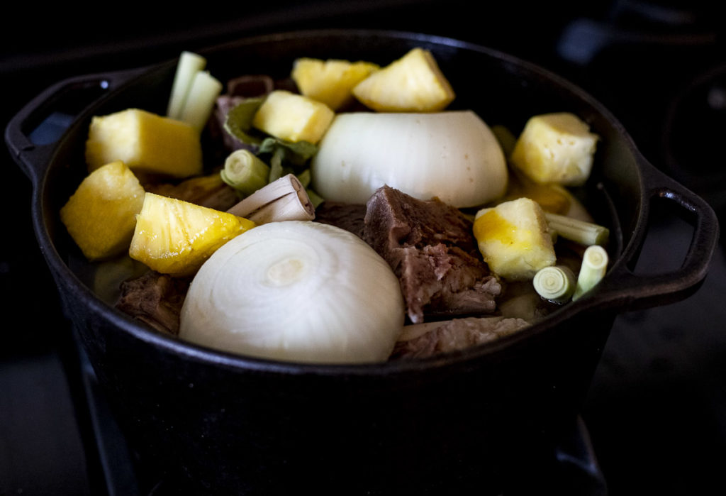 meat onions and pineapple in a large pot
