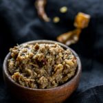 reddish brown curry paste in a wooden bowl