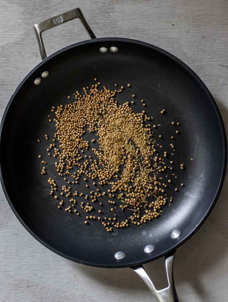 whole spices in a skillet