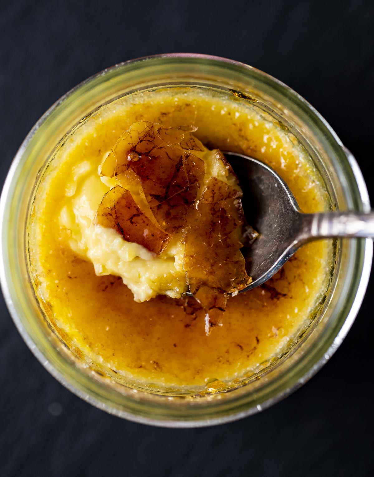 top down view of sppin breaking through a creme brulee caramelized top