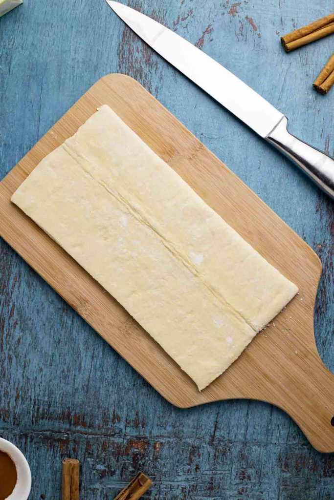 Photo of puff pastry on a cutting board.