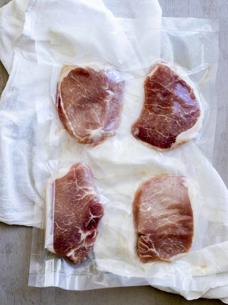 raw pork chops in a vacuum selaed bag