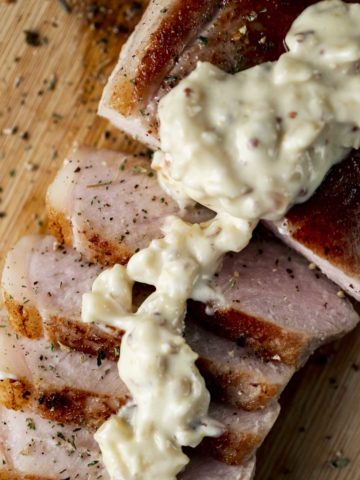 slices of pork drizzled with a white cream sauce