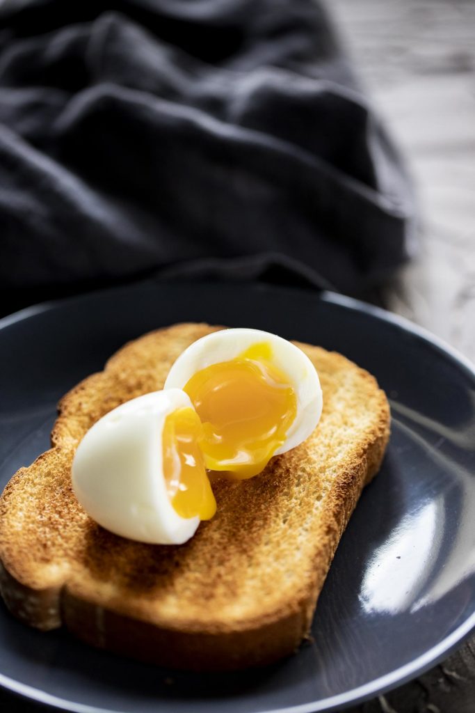 a soft boiled egg cut in half on a piece of toast