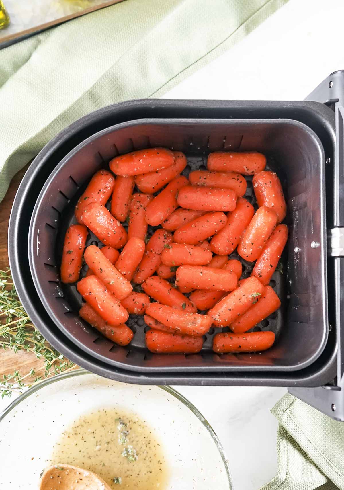 Glazed carrots placed in the air fryer basket.