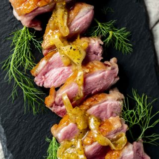 Duck breasts with orange glaze on top.