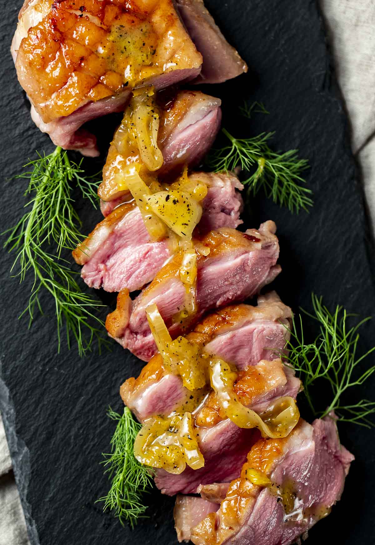 Duck breasts with orange glaze on top.