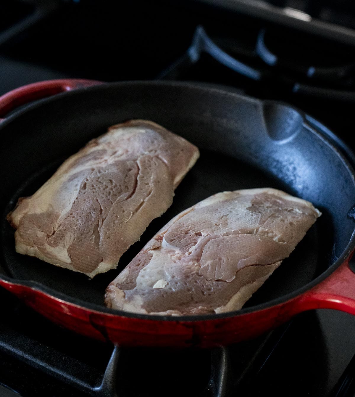 Searing the duck breasts skins in a cast iron.
