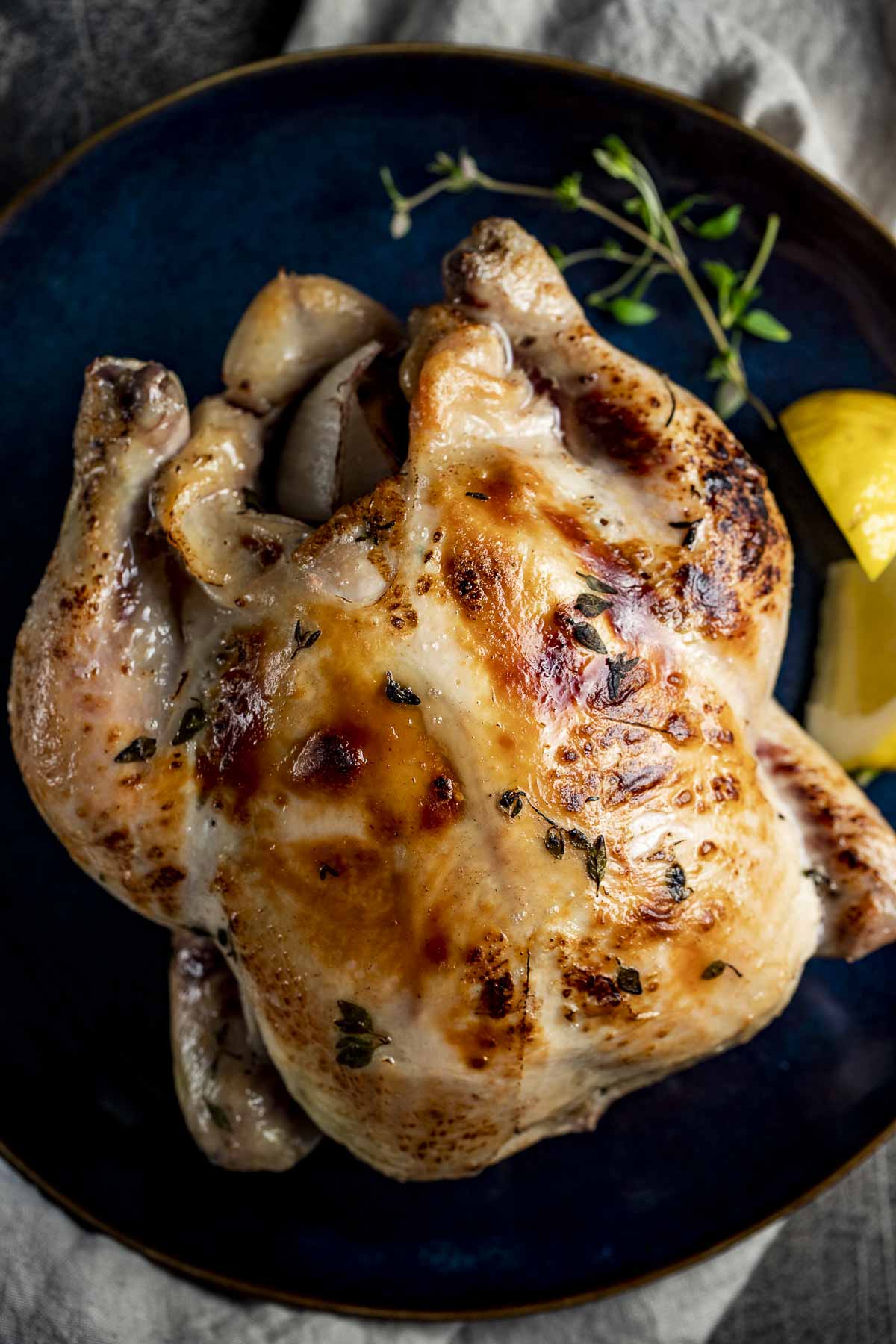Overhead view of a whole chicken with crispy golden skin.
