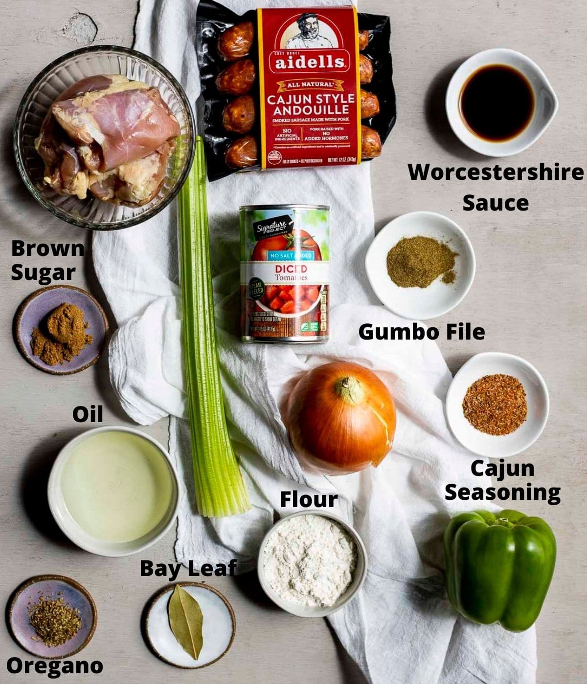 Ingredients to make Instant Pot gumbo arranged individually and labelled.