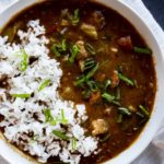 Instant Pot gumbo with chicken and sausage in a bowl and topped with rice.