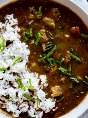 Instant Pot gumbo with chicken and sausage in a bowl and topped with rice.