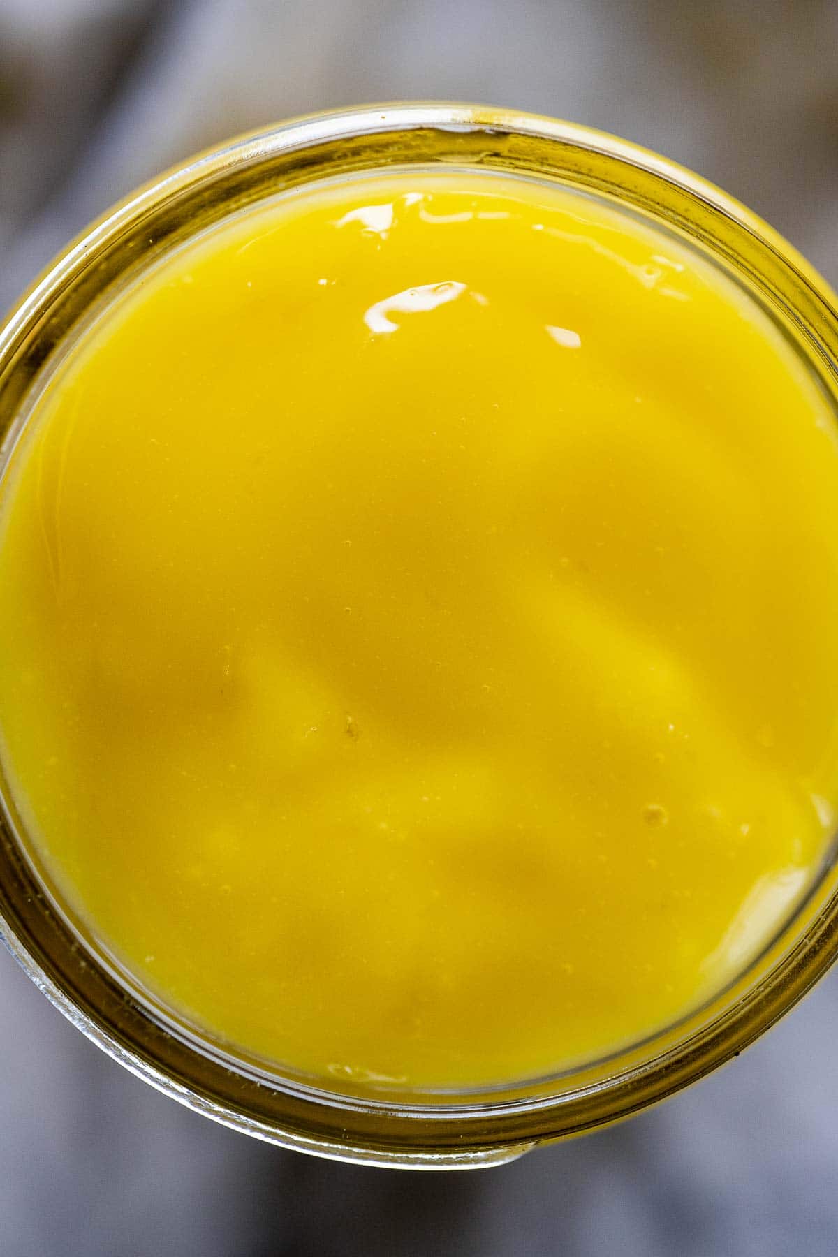 Overhead view of a jar of lemon curd.